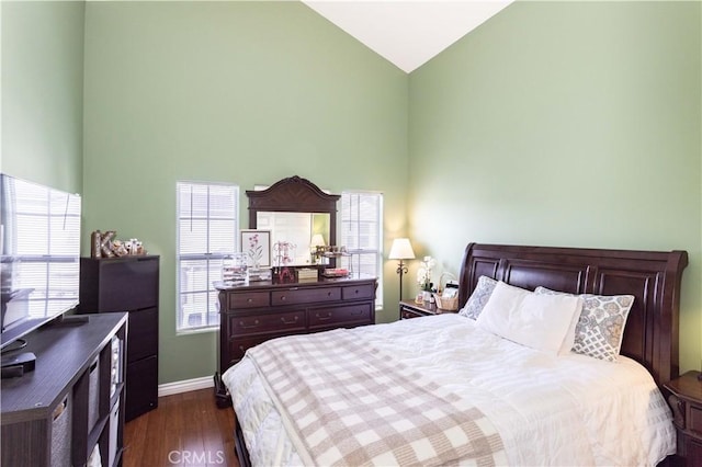 bedroom with baseboards, high vaulted ceiling, and dark wood finished floors