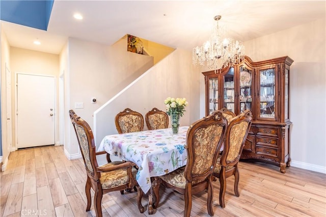 dining room with recessed lighting, a notable chandelier, light wood-style flooring, and baseboards