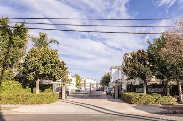 view of street with a gated entry, a residential view, and a gate