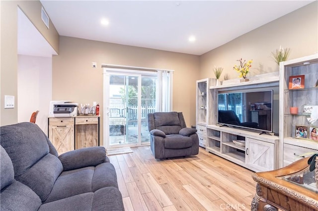 living room featuring recessed lighting, visible vents, and light wood-style flooring