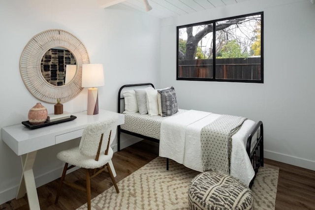 bedroom with dark hardwood / wood-style flooring