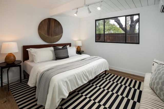 bedroom with beam ceiling, an AC wall unit, wooden ceiling, and dark hardwood / wood-style floors