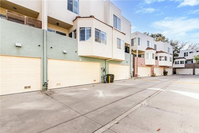 exterior space featuring a garage and a residential view