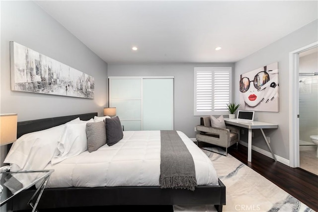 bedroom with wood finished floors, baseboards, a closet, and recessed lighting