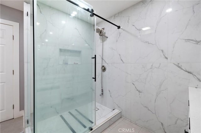 bathroom with a shower with shower door