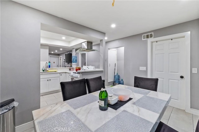 dining area with light tile patterned flooring and sink