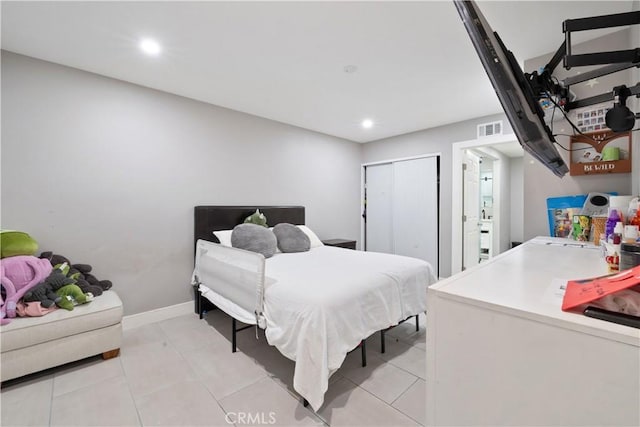 tiled bedroom featuring a closet