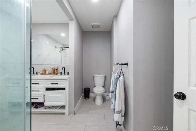 bathroom with an enclosed shower, vanity, toilet, and tile patterned floors