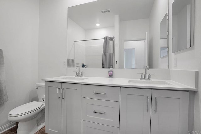 bathroom featuring vanity, curtained shower, and toilet