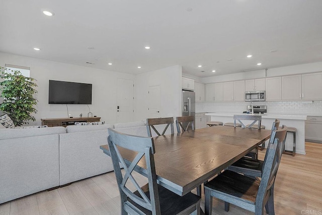 dining area featuring sink and light wood-type flooring