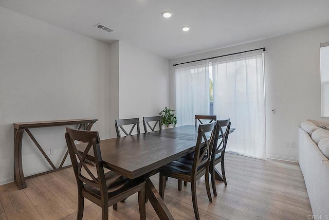 dining space with light wood-type flooring