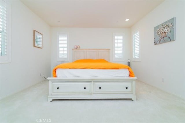 bedroom featuring light carpet