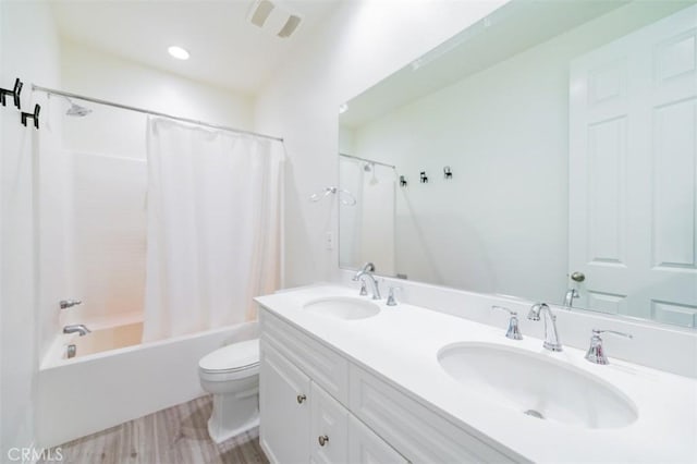 full bathroom featuring shower / bathtub combination with curtain, vanity, wood-type flooring, and toilet