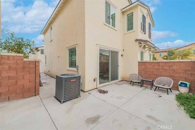 back of property featuring cooling unit and a patio area