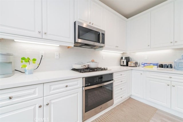 kitchen with stainless steel appliances and white cabinets