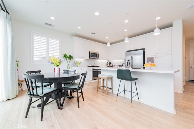 dining room featuring light hardwood / wood-style flooring