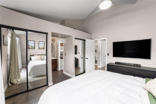 bedroom featuring vaulted ceiling, dark hardwood / wood-style floors, and ensuite bathroom