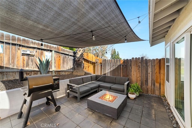 view of patio / terrace with grilling area and an outdoor living space with a fire pit