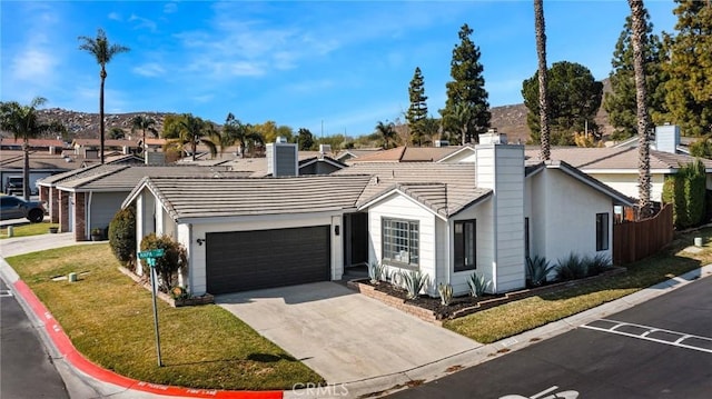 ranch-style home with a garage and a front yard