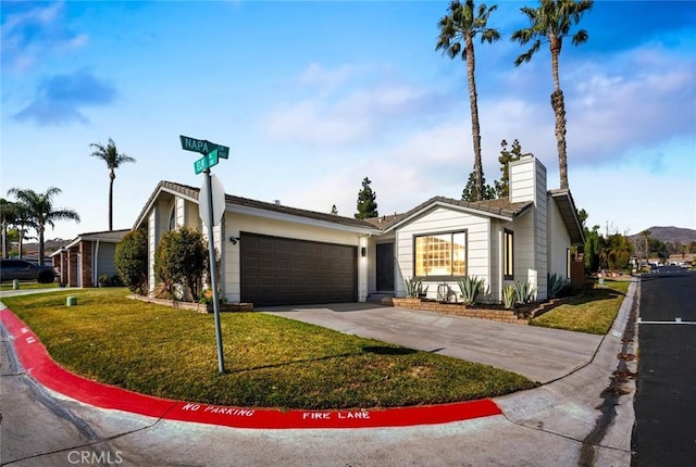 single story home featuring a garage and a front yard