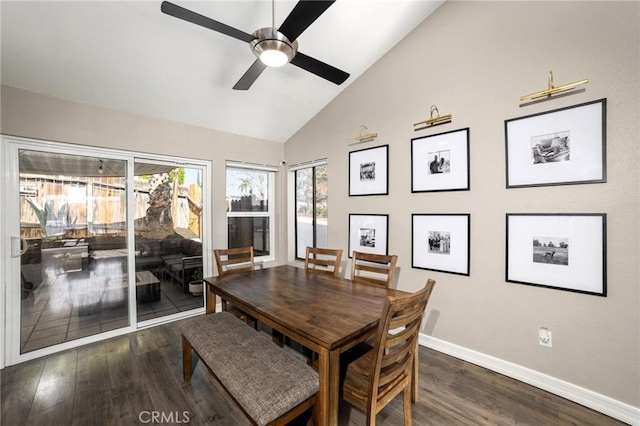 dining room featuring dark hardwood / wood-style flooring, lofted ceiling, and ceiling fan