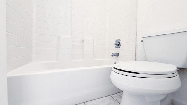 bathroom featuring bathtub / shower combination and toilet