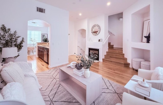 living room featuring sink and light hardwood / wood-style flooring