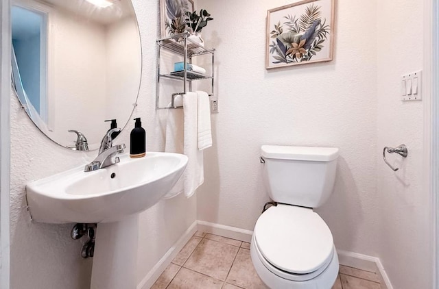 bathroom featuring toilet and tile patterned flooring