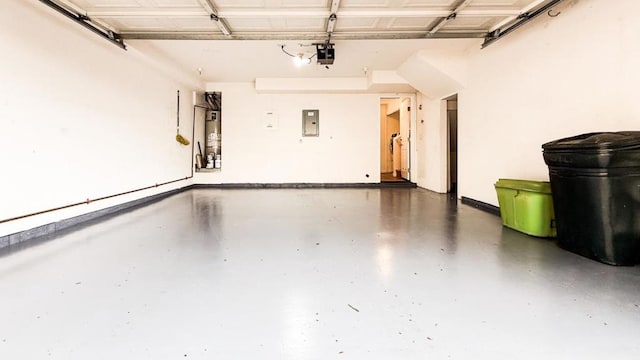 garage with a garage door opener, gas water heater, and electric panel