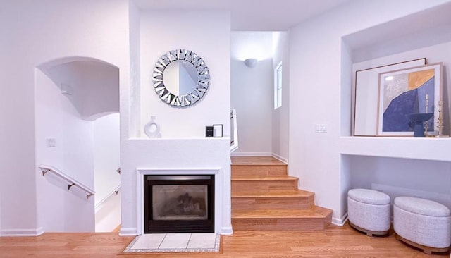 stairs with hardwood / wood-style floors