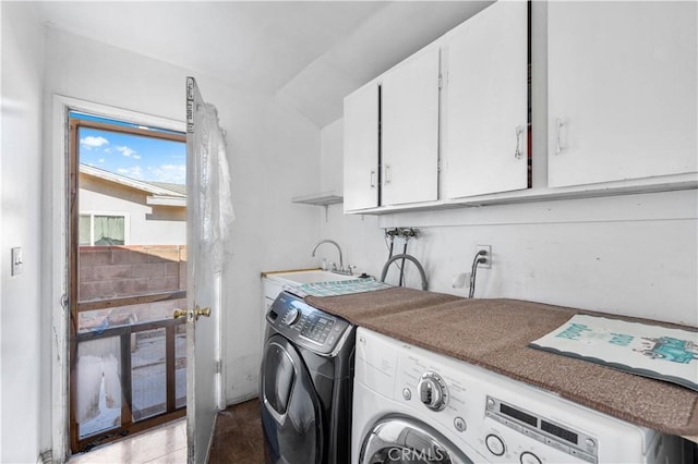 washroom with cabinets, separate washer and dryer, and sink