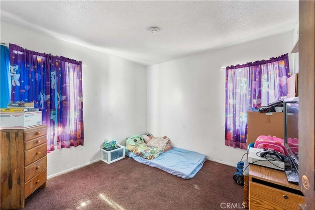 carpeted bedroom featuring a textured ceiling