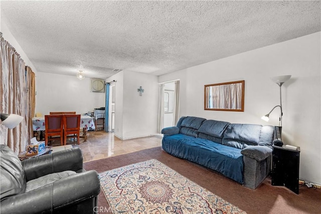 carpeted living room featuring a textured ceiling