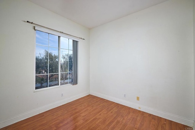 spare room with hardwood / wood-style flooring