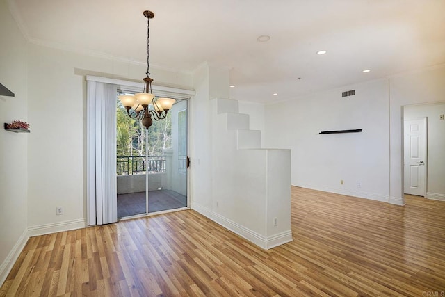 interior space with an inviting chandelier, crown molding, and light hardwood / wood-style flooring