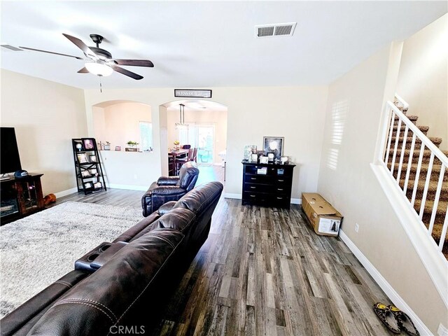 living room with hardwood / wood-style flooring and ceiling fan