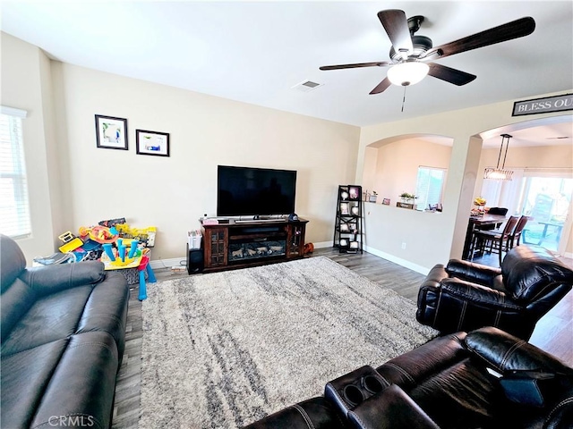 living room featuring hardwood / wood-style flooring and ceiling fan