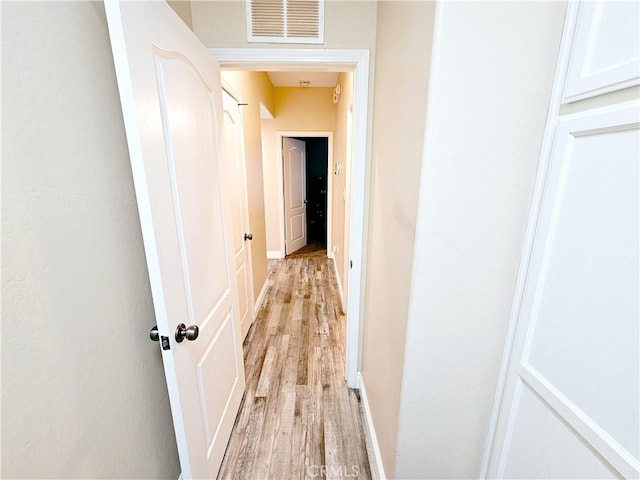 corridor with light wood-type flooring