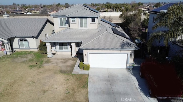 view of front of house with a garage and a front lawn