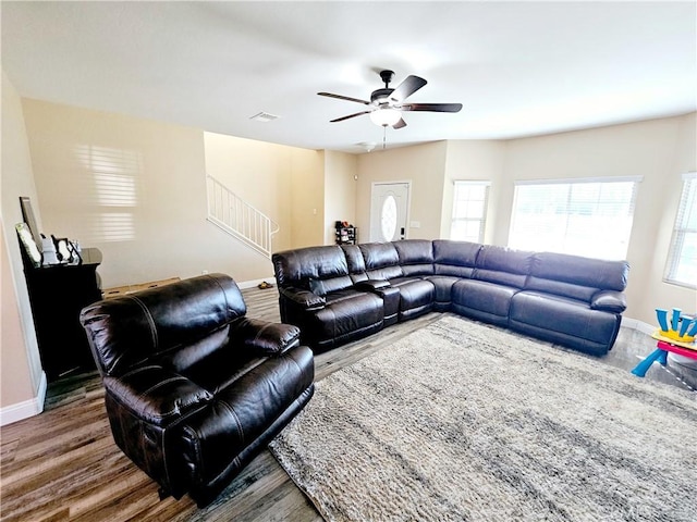 living room featuring dark hardwood / wood-style flooring and ceiling fan