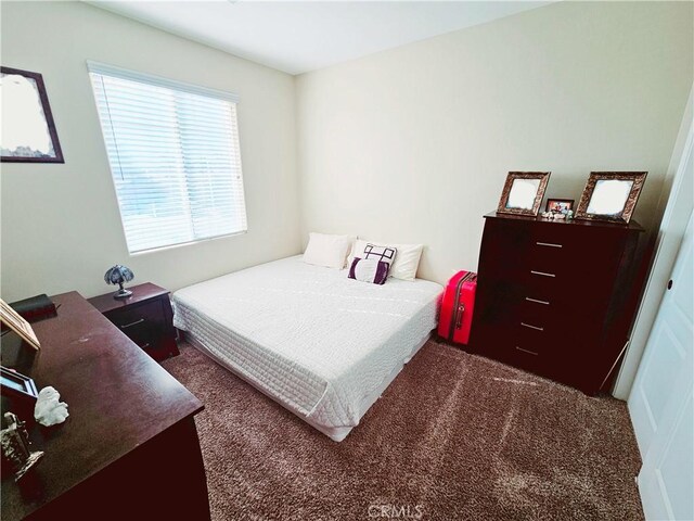 bedroom featuring dark carpet