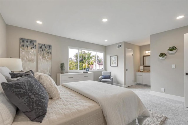 carpeted bedroom featuring connected bathroom