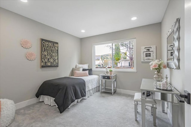 bedroom featuring light carpet