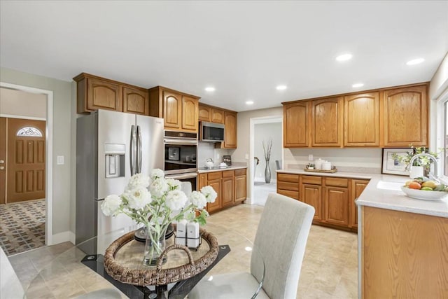 kitchen with stainless steel appliances, sink, and light tile patterned floors