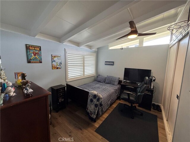 bedroom featuring vaulted ceiling with beams and hardwood / wood-style floors