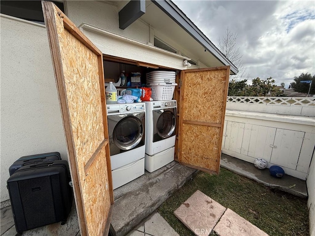 clothes washing area with independent washer and dryer