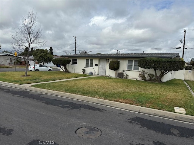 ranch-style house with a front yard, cooling unit, and fence