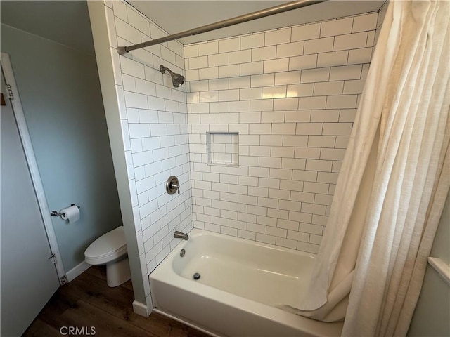 bathroom featuring shower / tub combo, toilet, and wood finished floors