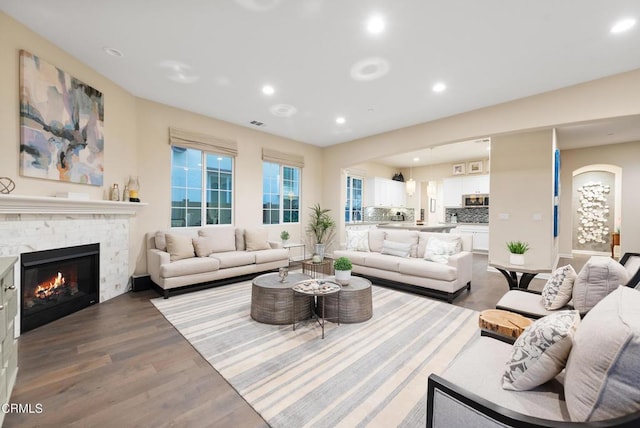 living room with hardwood / wood-style floors and a fireplace