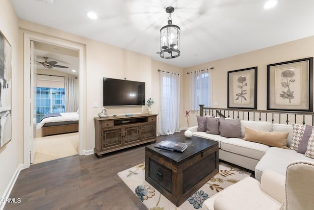 living room with a notable chandelier and dark hardwood / wood-style floors